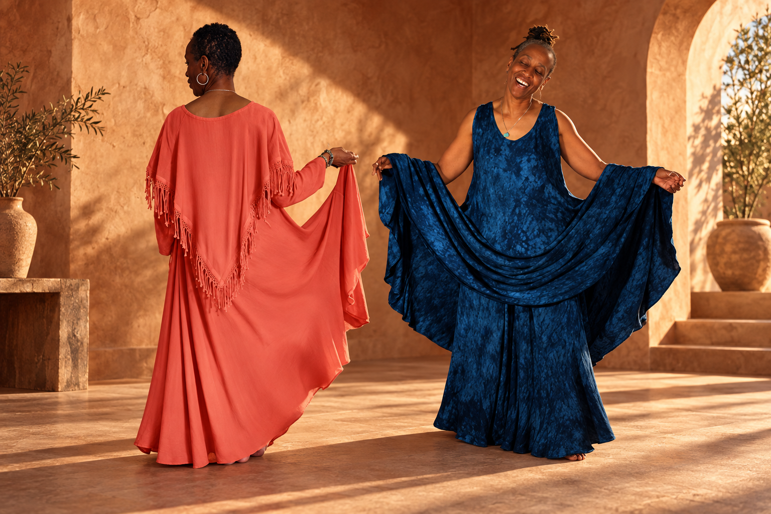 Coral and deep blue flowing dresses in a sunlit terracotta setting